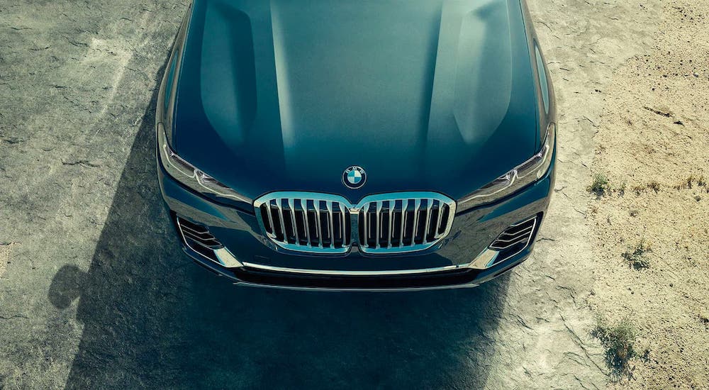 The front of a blue/gray 2020 BMW X7 is parked on a dirt lot outside Cincinnati, OH, shown from above.