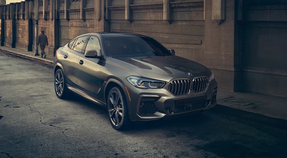A silver 2022 BMW X6 is shown parked on a side street after a Cincinnati BMW lease deal.