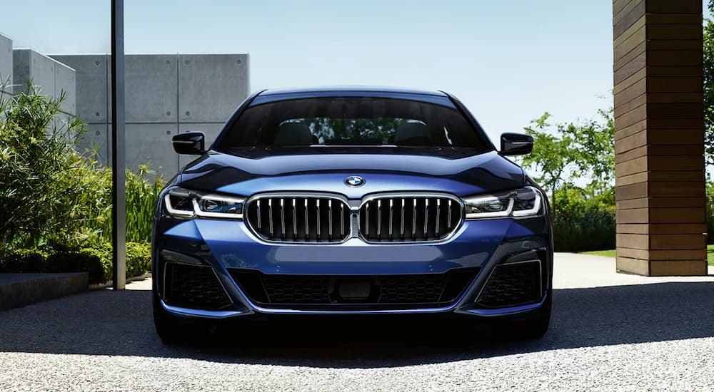 A blue 2022 BMW 5 Series sedan is shown from the front.