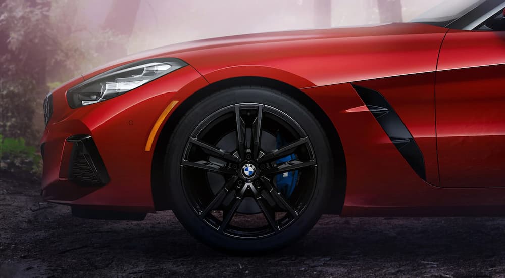 A red 2022 BMW Z4 M40i is shown from the side parked at a used BMW dealer near you.
