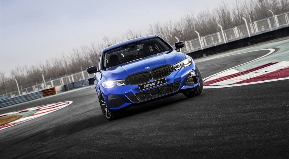 A blue 2022 BMW 3 Series is shown from the front on a race track after leaving a BMW Dealership in Cincinnati, Ohio.