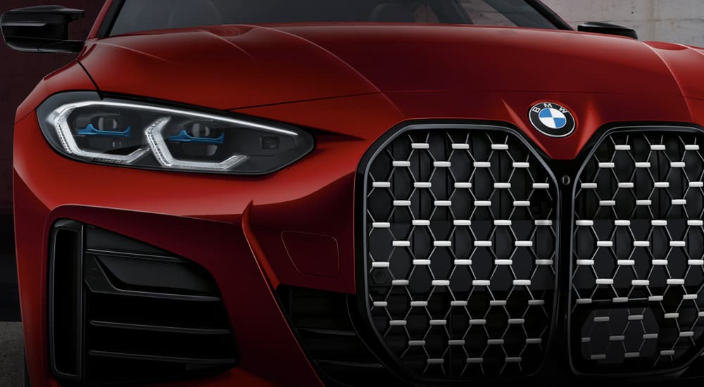 A close up shows the headlight and grille on a red 2022 BMW B4 Alpina after leaving a Dayton BMW dealer.