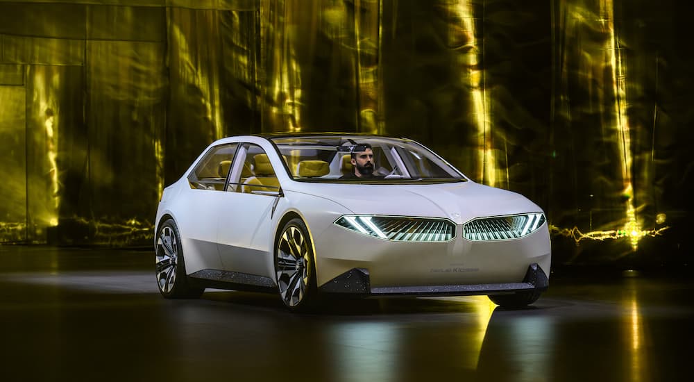 A white BMW Vision Neue Klasse is shown from the front at an angle.